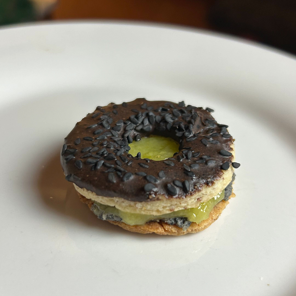 Black Sesame Butter & Mango Linzer Cookie on a white plate