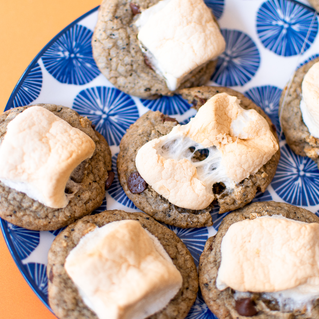 A ripped open cookie with melt-y marshmallow on top.