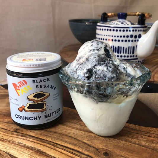 Homemade Black Sesame Ice Cream set on table next to jar of Black Sesame Crunchy Butter.