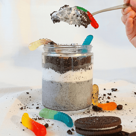 Black sesame pudding with gummy worms, created using Rooted Fare's Black Sesame Crunchy Butter. The perfect Halloween treat.